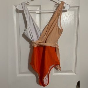 Orange, peach, and white one piece bathing suit